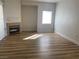 Bright, open living area with modern fireplace and wood-look flooring at 3318 N Decatur Blvd # 1056, Las Vegas, NV 89130