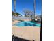 Community pool surrounded by palm trees and deck chairs, perfect for relaxation at 3318 N Decatur Blvd # 1056, Las Vegas, NV 89130