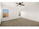 Spacious bedroom with carpet, ceiling fan, two windows, and neutral decor at 354 Sunward Dr # 0, Henderson, NV 89014