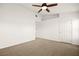 Spacious carpeted bedroom with fan, neutral walls, and a hallway view at 354 Sunward Dr # 0, Henderson, NV 89014