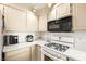 Kitchen featuring white cabinets, countertops, a microwave, and gas stovetop with black accents at 354 Sunward Dr # 0, Henderson, NV 89014