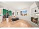Open-concept living room featuring a modern kitchen, fireplace, and bright windows at 354 Sunward Dr # 0, Henderson, NV 89014