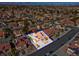 Neighborhood view of property with red tile roofs, solar panels, desert landscaping, and a blue outline for lot boundaries at 37 Stone Cress Dr, Henderson, NV 89074