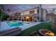 Serene backyard featuring a sparkling pool, fire pit, and covered patio, perfect for entertaining at 37 Stone Cress Dr, Henderson, NV 89074
