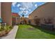A well-manicured backyard featuring artificial turf and desert landscaping at 37 Stone Cress Dr, Henderson, NV 89074