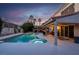 Beautiful backyard with a pool, hot tub, covered patio, and lush landscaping, perfect for relaxing at 37 Stone Cress Dr, Henderson, NV 89074