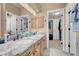 Bathroom featuring double sinks, vanity with cabinets, mirror, and walk-in closet at 37 Stone Cress Dr, Henderson, NV 89074