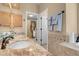 Bright bathroom featuring double sinks, walk-in closet and decorative tile accents at 37 Stone Cress Dr, Henderson, NV 89074