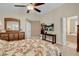 This bedroom features a dresser, ceiling fan, and doorway leading to a bathroom at 37 Stone Cress Dr, Henderson, NV 89074