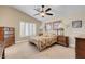 Comfortable bedroom featuring neutral tones, ceiling fan, and shuttered windows for great natural light at 37 Stone Cress Dr, Henderson, NV 89074