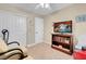 A cozy bedroom with a TV, bookshelf, neutral walls, and a ceiling fan at 37 Stone Cress Dr, Henderson, NV 89074