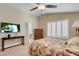 This bedroom has a television, large window, and doorway leading to a bathroom at 37 Stone Cress Dr, Henderson, NV 89074