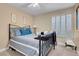 Light and airy bedroom featuring vaulted ceiling, large windows, and ceiling fan at 37 Stone Cress Dr, Henderson, NV 89074