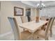 Elegant dining room with a chandelier, six chairs and modern shuttered windows creating an ideal ambiance at 37 Stone Cress Dr, Henderson, NV 89074
