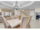 Elegant dining room with a chandelier, six chairs and modern shuttered windows creating an ideal ambiance at 37 Stone Cress Dr, Henderson, NV 89074