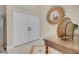 Inviting entryway with double doors, tile flooring, decorative table, and a stunning sunburst mirror accent at 37 Stone Cress Dr, Henderson, NV 89074