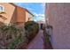 Charming walkway leading to home entrance amidst lush landscaping and warm-toned exterior at 37 Stone Cress Dr, Henderson, NV 89074