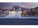 Charming two-story home featuring a three-car garage, desert landscaping, and a red tile roof with solar panels at 37 Stone Cress Dr, Henderson, NV 89074
