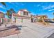 Charming home boasts a three-car garage, red tile roof, desert landscaping, and a spacious driveway, perfect for families at 37 Stone Cress Dr, Henderson, NV 89074