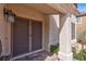 Welcoming front entrance featuring a secure screen door, brick pathway, desert landscaping, and an inviting 'Welcome' mat at 37 Stone Cress Dr, Henderson, NV 89074