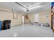 An organized garage with storage shelves, painted floors, and ample space for vehicles at 37 Stone Cress Dr, Henderson, NV 89074