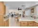 Open-concept kitchen with granite countertops and stainless steel appliances with views into the living room at 37 Stone Cress Dr, Henderson, NV 89074