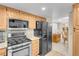 Well-equipped kitchen features stainless steel appliances, light wood cabinets, and stone countertops at 37 Stone Cress Dr, Henderson, NV 89074