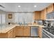 Well-lit kitchen with granite countertops, stainless steel appliances, and custom wood cabinets at 37 Stone Cress Dr, Henderson, NV 89074