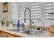 Close-up on kitchen sink and faucet with granite countertop and custom shutters at 37 Stone Cress Dr, Henderson, NV 89074