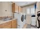Functional laundry room featuring granite countertops, a sink, and modern appliances at 37 Stone Cress Dr, Henderson, NV 89074