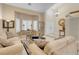 Inviting living room with high ceilings, neutral decor, plantation shutters, and an elegant grandfather clock at 37 Stone Cress Dr, Henderson, NV 89074