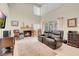 Spacious living room with fireplace, vaulted ceilings, and open floor plan at 37 Stone Cress Dr, Henderson, NV 89074