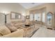 Inviting living room with high ceilings, neutral decor, plantation shutters, and an elegant grandfather clock at 37 Stone Cress Dr, Henderson, NV 89074