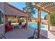 Inviting covered patio with ample seating and a sparkling pool, ideal for outdoor relaxation at 37 Stone Cress Dr, Henderson, NV 89074