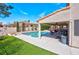 Inviting backyard oasis featuring a sparkling pool, covered patio, and lush landscaping for ultimate relaxation at 37 Stone Cress Dr, Henderson, NV 89074