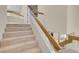 Carpeted staircase with wooden and white railing offering access to the home's living spaces at 37 Stone Cress Dr, Henderson, NV 89074