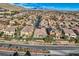 Expansive aerial view of a residential community featuring well-maintained homes and scenic mountain backdrop at 4087 Villa Rafael Dr, Las Vegas, NV 89141