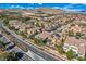 Scenic aerial view showcasing a residential neighborhood with lush landscaping and mountain views at 4087 Villa Rafael Dr, Las Vegas, NV 89141