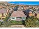 Aerial view of a well-maintained home with a lush green backyard and nearby mountain views at 4087 Villa Rafael Dr, Las Vegas, NV 89141