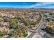 Panoramic aerial view of a community entrance, showcasing lush landscaping, mature trees, and a serene lake at 4087 Villa Rafael Dr, Las Vegas, NV 89141