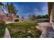 Lush backyard featuring a stone patio and vibrant greenery, creating a private outdoor oasis at 4087 Villa Rafael Dr, Las Vegas, NV 89141
