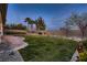 A well-maintained backyard with lush greenery and a charming stone patio at 4087 Villa Rafael Dr, Las Vegas, NV 89141