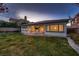 Backyard featuring lush green grass and a covered patio with ample seating at 4087 Villa Rafael Dr, Las Vegas, NV 89141