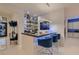 Modern bar area with stylish blue chairs, sleek countertops, and elegant glass shelving for drinks at 4087 Villa Rafael Dr, Las Vegas, NV 89141