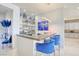 Stylish bar area with elegant blue chairs, custom shelving, and contemporary lighting at 4087 Villa Rafael Dr, Las Vegas, NV 89141