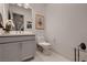 Modern powder room features a vanity with sink, toilet, and stylish decor at 4087 Villa Rafael Dr, Las Vegas, NV 89141
