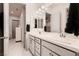 Elegant bathroom with double sinks, grey cabinets, and white marble flooring throughout at 4087 Villa Rafael Dr, Las Vegas, NV 89141