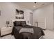 Comfortable bedroom featuring a queen bed, modern decor, white shutters, and marble tile flooring at 4087 Villa Rafael Dr, Las Vegas, NV 89141