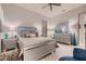 Bright bedroom with a beautifully decorated bed, mirrored furniture, and a comfortable blue chair at 4087 Villa Rafael Dr, Las Vegas, NV 89141