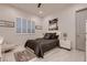 Cozy bedroom featuring a comfortable queen bed, white shutters, and marble tile flooring at 4087 Villa Rafael Dr, Las Vegas, NV 89141